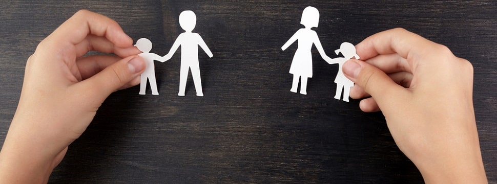 broken family concept, divorce. child hands with broken paper cut fmily